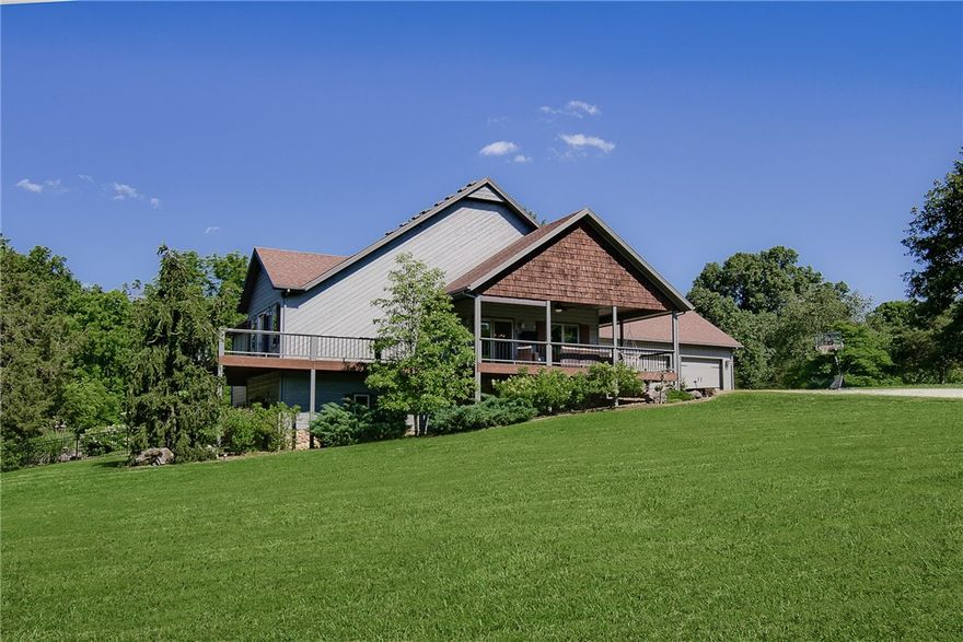 Rare chance to own 5 private, wooded acres just minutes from Bentonville! This spacious 3534 SF home is move-in ready with an inviting in-ground pool, large scenic deck, and covered front porch perfect for entertaining or relaxing in nature. Modern kitchen features quartz counters, gas range, custom cabinetry, and island seating. Vaulted living area with panoramic views and abundant light. Luxurious primary suite with private balcony, walk-in closet, spa-like bath with double vanities, tiled shower, and sauna. Finished walk-out basement offers a large family room, full bar with seating, game area, and extra bedrooms for guests or office. Landscaped yard with mature trees ensures privacy. Oversized laundry room with built-ins, attached 3-car garage, and ample storage throughout. Ideal for buyers wanting acreage, space, and seclusion without giving up quick access to Bentonville schools, shopping, trails, and all Northwest Arkansas amenities.