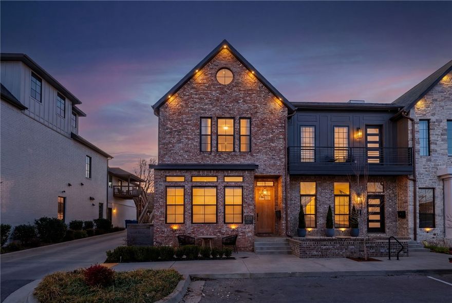 Located in the heart of downtown, this character-filled home offers rare flexibility for commercial or residential use-ideal for a live-work lifestyle or investment. Arched openings, tall ceilings, & oversized doors create a grand visual experience throughout, while black windows, doors, and trim pair beautifully with gold & black fixtures. The main level features white oak engineered hardwood floors, a gas-burning fireplace, dedicated bar area, spacious dining room, gas range, walk-in pantry, half bath, & additional storage beneath the stairs. Upstairs, a light-filled loft with metal railing anchors the space, along with a laundry room & three large bedrooms. The primary suite showcases vaulted ceilings w/ wood beam, dual closets, private toilet room, quartz countertops, & dual-head tiled shower. One secondary bedroom includes an en-suite bath, while the remaining bedroom is served by a full half bath. Additional highlights include keyless entry, internet boosters, an oversized two-car garage & private side patio.