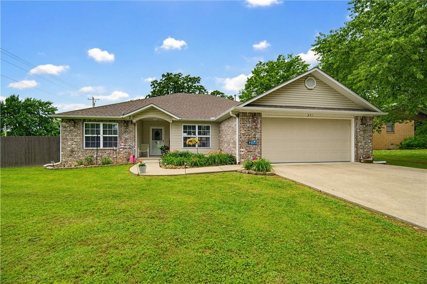 This well-maintained brick and vinyl home in Gentry sits on a spacious level corner lot. The functional floor plan includes a versatile room off the entry that can serve as a formal dining room, a dedicated study, or a 4th bedroom. Interior highlights feature Armstrong rigid core flooring in high-traffic areas, granite countertops with a kitchen pantry, and a master suite with a trey ceiling and walk-in closet. Enjoy large rooms with LED lighting throughout. The exterior is complete with a covered back patio, full guttering, and a sodded front yard. Located in close proximity to town amenities.