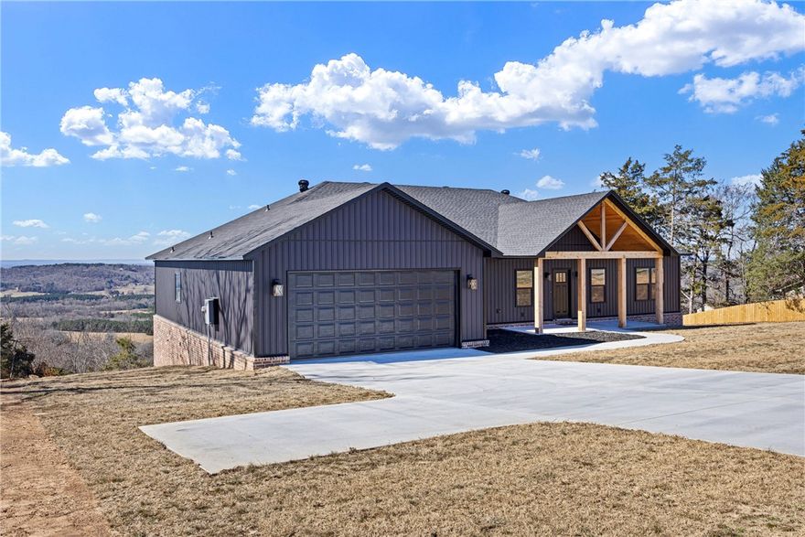 Welcome to Crow Mountain living at its best, where peaceful surroundings and breathtaking valley views meet thoughtful new construction. This 3 bedroom, 2 bath home was designed to feel both modern and inviting from the moment you arrive. The striking black exterior with cedar accents creates beautiful curb appeal, while inside an open layout filled with natural light draws your eye straight to the incredible views beyond. Luxury vinyl plank flooring, warm finishes, and clean modern fixtures create a comfortable everyday living space. The kitchen offers an oversized walk-in pantry with pull-out storage and instant hot water tap, perfect for both busy mornings and entertaining. A split floor plan provides privacy, and the primary suite features a relaxing soaking tub, tiled walk-in shower, and spacious walk-in closet. Enjoy quiet mornings or sunset evenings on the covered back deck with wood ceilings and modern railing. Located in the desirable Crow Mountain area with a sodded front yard and Pottsville Schools.
