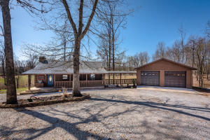 Very cute 2 bedroom 1 bath cabin nestled on approximately 7.51 acres surrounded with pipe fence. Home includes hardwood floors, granite counter tops, and much more. Large two car detached garage with extra storage. Sit peacefully on your large back deck and enjoy the wildlife!