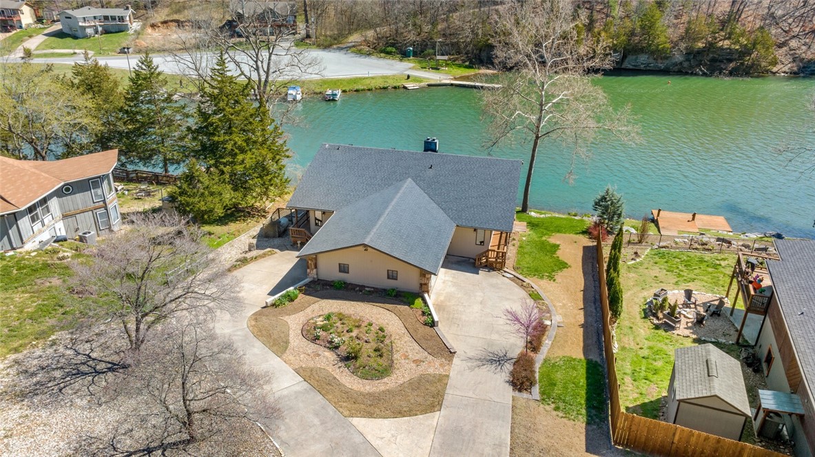 Don't miss this Lake Ann lakefront beauty, with two levels of wrap around decking and just a few steps to the home's private dock. This 3 bedroom, 3 bath home has two living areas with fireplaces, an eat in kitchen, craft room and workshop - all under air. The oversized windows throughout let the natural light in, and the views from nearly every room are amazing.