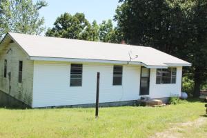 Country living on paved road with 13 acres m/l in Bergman School District. 3 BR 1 bath home with tons of potential! All #'s are approx., age is estimate, sq. footage per assessor, buyer to verify existence of septic.