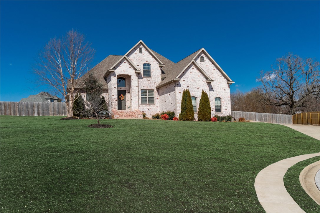 Perfectly situated at the end of a cul-de-sac in the coveted Nevaeh Estates of Cave Springs, this 2-level home combines style, space, and function. With the primary suite and an additional bedroom on the main level, plus two guest bedrooms and a large bonus room upstairs, this home is perfect for any family. Enjoy high ceilings, wood flooring, custom lighting, and a chef-worthy kitchen featuring stainless steel KitchenAid appliances, a butler’s pantry, and a formal dining room. The primary suite features a spa-like walk-through shower, soaking tub and large walk-in closet. The updated back patio is ready for entertaining and offers plenty of space for a pool or shop. This home is wheelchair accessible, with 5' sidewalks around the house, and features a storm shelter, large fire pit, and extra parking. Zoned for Bentonville schools and just minutes from XNA, Bentonville, and Fayetteville, this is a perfect blend of convenience and comfort.