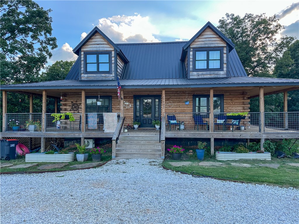 Beautiful custom log home on 2.5 acres just few miles north of Pea Ridge, one of NWA's great communities. Home has 3 levels, vaulted main living area, finished walkout basement which is a separate living area and is used as an AirBNB rental. Could be an apartment or extended family home. Huge wrap around covered porch on three sides, over 900 sq ft, looks over the above ground pool, shop and recreation area. Most of the furniture will convey. 40x60x12 red iron insulated shop with an 800 sq ft appt also used as AirBNB and/or apartment rental. Shop has 3 10x10 doors, 2 walk in doors and a 20x60 covered cement area in front of the shop with pickle ball and volleyball court. Truck lift doesn’t convey but can be purchased. Looking for a great country place that's not far from everything NWA, come check this out!! Bike riding starts here!!