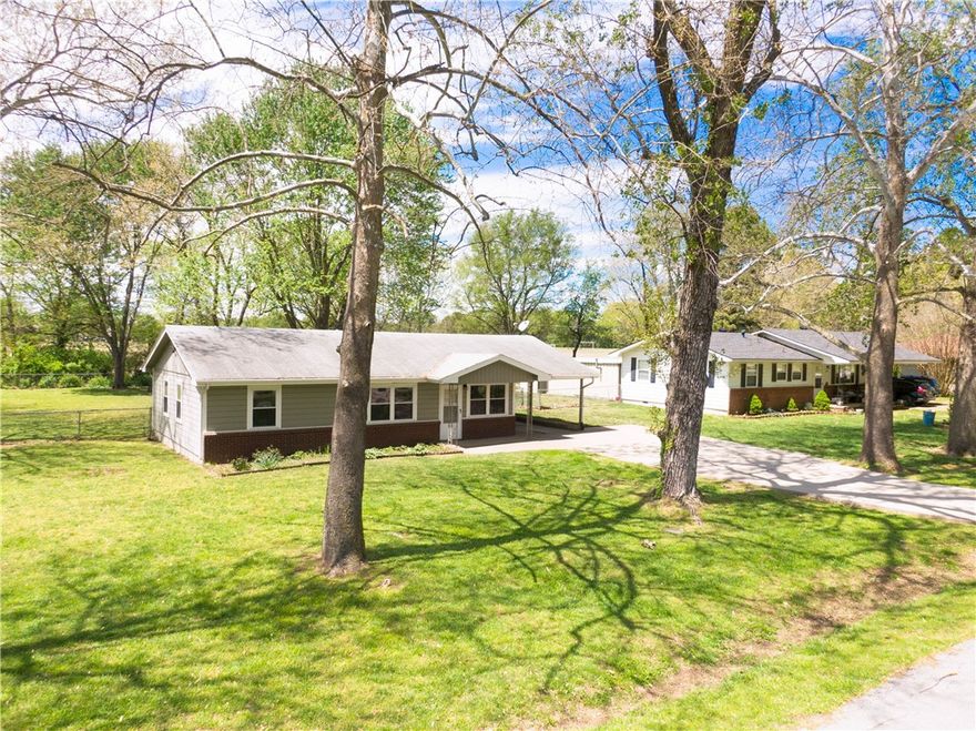 Charming two-bedroom, one-bathroom home boasts a spacious open kitchen that seamlessly flows into the LR, creating an inviting & comfortable living space. Interior features include laminate flooring that adds a fresh and modern touch to the home. Situated on an almost half-acre lot, the property offers a generously sized backyard adorned with mature trees, providing a serene and shaded retreat. Perfectly catering to the needs of University life, this home is conveniently located within walking distance to the University of Arkansas. For those seeking convenient transportation options, the nearby University of Arkansas bus stop ensures easy commuting. The property also features a newer roof, providing peace of mind & a well-maintained exterior.
