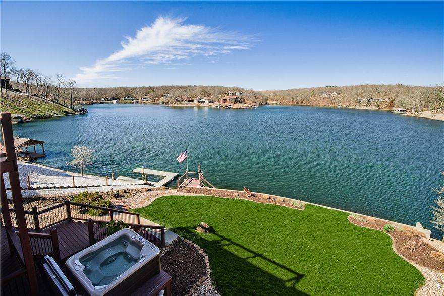 Relaxing lake living is waiting for you to enjoy! Amazing views captured on the expansive upper or lower decks. This stunning custom one owner home boasts massive windows capturing the view inside the home and truly creating the “wow” factor you’ll want to daily enjoy. 99’ shoreline and gentle walk to the lake for a swim or boat ride, this lakefront home will surely please all. Watch the boats go by in the new hot tub or entertain friends and family on the multiple outdoor living spaces. Quality built with awesome floor plan, every detail of this home has been meticulously designed and cared for. Mother in law suite on main level perfect for guests, parents, or children’s room. Downstairs showcases impressive height ceilings and kitchenette area, exercise room, bedroom and massive storage. Don’t miss out on the opportunity to live in and enjoy this beauty!  Cannot close prior to May17. Not subject to appraisal. Home has been pre-inspected with licensed home inspector.