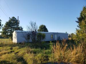 1.95 acres with fruit trees. Mobile home in need of major repairs to convey with property.