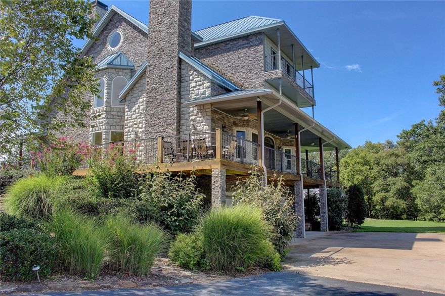 Built for entertaining and designed to allow for an elevator, but with complete privacy just minutes from Fayetteville. The 12.9 acres of Land is perfect for horses, and the home includes vaulted and high ceilings in the living areas, individual bathrooms for each bedroom, custom cabinetry and trim with designer kitchen, on-site hand scraped wood flooring, exposed beams, multiple living areas including a private country style theater, wrap-around decks, covered exterior kitchen, swimming pool, separate pool house, barns, ponds and 6 car garage.  Pool house included in sqft. with updates to include shower and door straight to pool area.