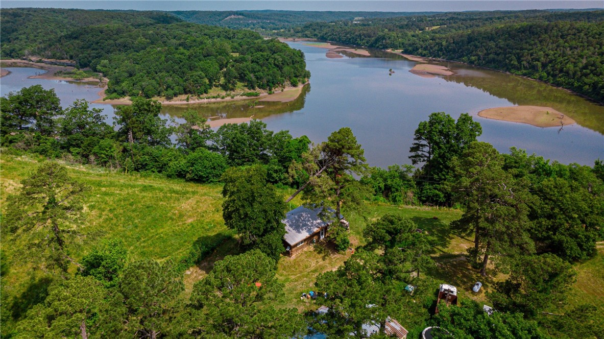 AUCTION 7/6/2023 at 10:00 AM
Secluded retreat/recreational property consisting of just under 70 acres with views of Beaver Lake! This property includes a 2-bedroom cabin and a 30' x 40' shop building with (2) bay doors. Make this property your own!
10% buyer's premium