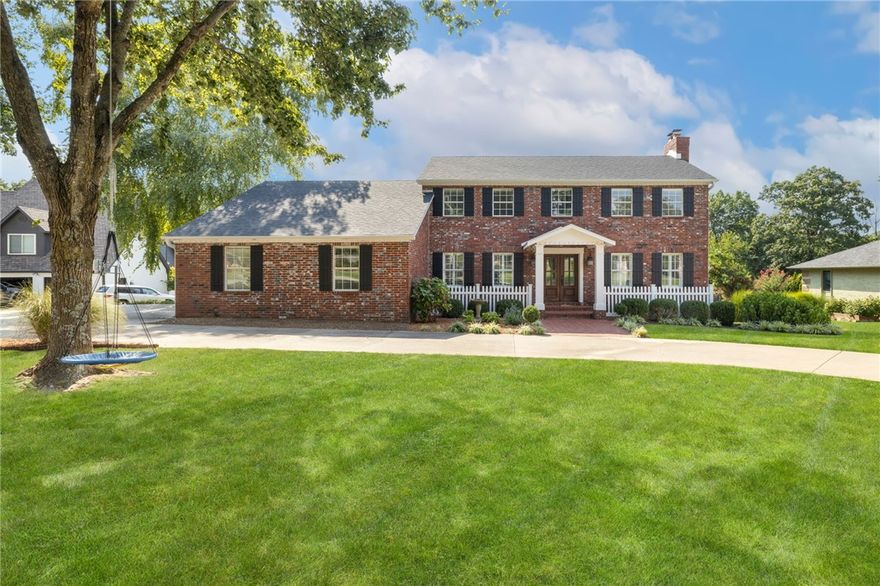 Escape to this stunning Federal-style dream home perfectly situated on a half-acre lot less than five minutes from Downtown Bentonville. Enjoy your morning coffee on the spacious screened-in porch, which offers a view of the in-ground pool.  Experience the best of Bentonville's outdoor lifestyle with direct access to the Applegate Trail, connecting you to the renowned Coler Mountain Bike Preserve. Whether you're heading out for a bike ride or a dog walk, adventure is right outside your door.
Step inside to discover a home where classic charm meets modern luxury. The kitchen has been fully remodeled, offering contemporary style and functionality.  Hardwood floors throughout the main level, where a cozy den awaits with a wood-burning fireplace.  Upstairs, the expansive primary suite offers a private retreat, complete with a fully remodeled bathroom and a second wood-burning fireplace. This home is as practical as it is beautiful, with tons of storage and professional landscaping that enhances its curb appeal.