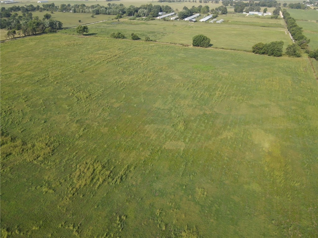 Step into the serenity of this expansive 40-acre parcel of land, a haven with road frontage on two sides and the convenience of rural water at the street. The property is fully fenced, providing security and a sense of boundless freedom. Enjoy the ease of access with paved road on one side, making your journey to and from town a breeze. The level, open pasture beckons with possibilities, featuring a tranquil pond that is perfect for livestock and lends itself beautifully to creating a homestead. Experience the tranquility of a rural setting while being just a short 5 miles drive to town. Whether you dream of a peaceful retreat, a thriving farm, or a new home set against a backdrop of natural beauty, this property offers the perfect blend of rural charm and accessibility for discerning buyer.