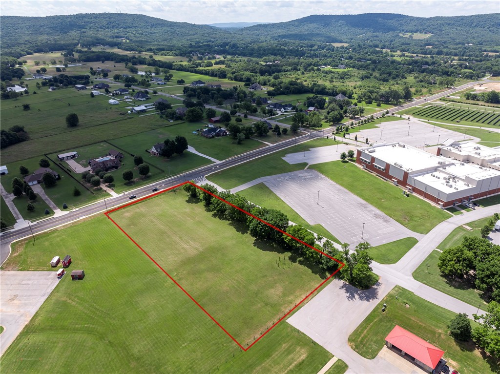 **Prime 2.25-Acre Commercial Opportunity** near the new Farmington High School and ball fields. Located on a developing arterial road designed to divert traffic from Main Street—ideal for visibility and access. Surrounded by growing subdivisions and thriving residential development. Perfect location for indoor pickleball courts, daycare, medical or dental offices, or a neighborhood retail strip center. All uses are subject to city planning approval. Excellent site for forward-thinking investors or developers seeking high-growth potential. Less than 5 miles to I-49, Fayetteville, and all that it offers. Buyer to verify utilities on site and requirements for connections.