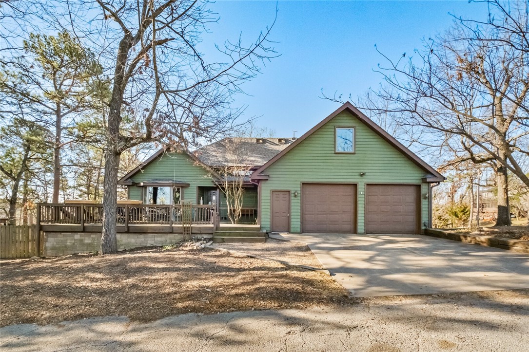 Open house for sunday april 6 has been cancelled. Stunning custom built cedar home offering unparalleled comfort and functionality. It sits on 1.38 acres and has a year-round view of Beaver Lake. This home has 4 bedrooms and 3.5 bathrooms complimented with a 1500 sq ft heated/cooled workshop. The first floor of the home boasts a gourmet kitchen with modern appliances and knotty alder wood floors. The living room features a wood-burning stove and has a rustic and warming feel. The basement includes 2 bedrooms / 1 bathroom with a 2nd living space and office. Additionally you will find the 3rd car garage which is perfect for extra storage. Outside there are several spots to entertain guests or just relax on the surrounding decks. The pet-friendly fenced dog kennel ensures a safe and comfortable space for your pets. The detached shop is a great place for any hobby and can be used year round. Rocky Branch Marina is just 10 minutes away. The tranquility and functionality of this home can't be matched. Schedule today!