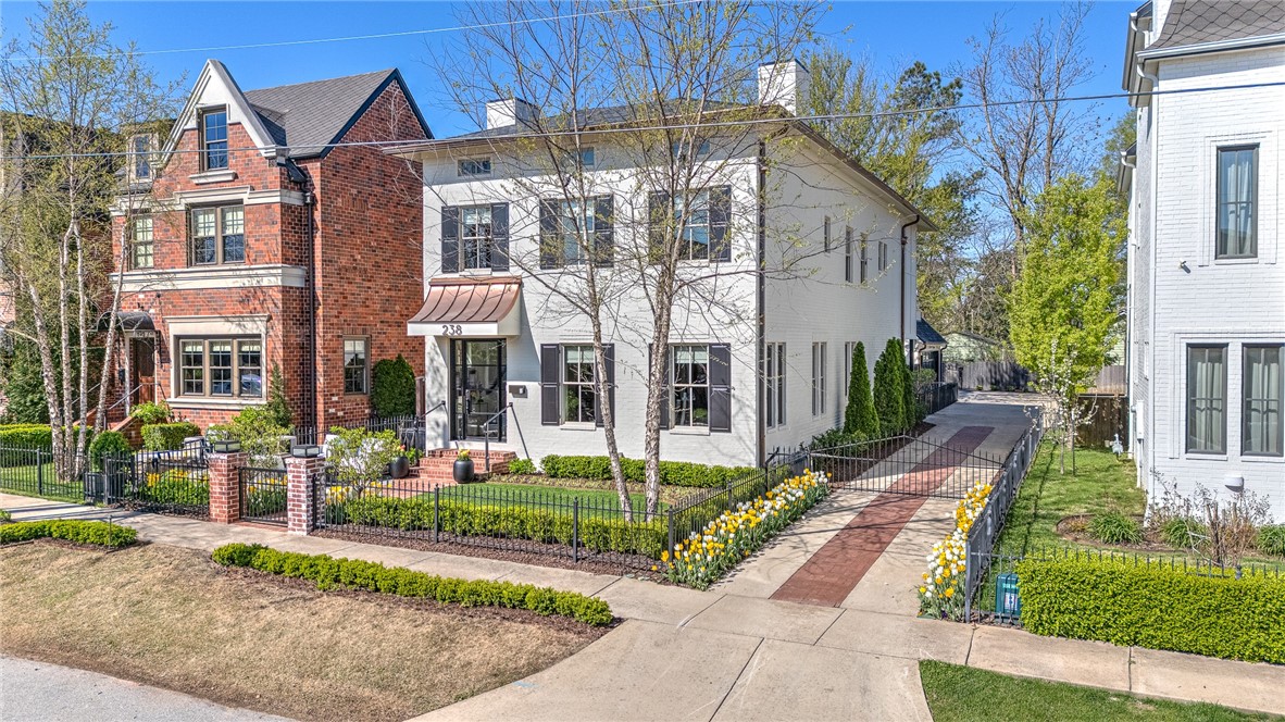 WELCOME TO THIS DAZZLING, FULLY REMODELED SHOWSTOPPER LOCATED ON ONE OF DOWNTOWN BENTONVILLE’S MOST ICONIC STREETS JUST 3 BLOCKS FROM THE SQUARE! No expense was spared in this ultra LUXURIOUS home offering a 3,269 sq ft main home and a detached heated & cooled 2 car garage with 379 sq ft guest suite above…offering an elevator in both the main home and garage! Dreamy curb appeal, immaculate landscaping and a gated driveway all set the tone for the elegance within! The stylish and sleek living and dining spaces flow beautifully into the fabulous gourmet kitchen boasting top of the line appliances including 2 dishwashers, multiple ovens, butler’s pantry and tons of space to prep & entertain! Relax and unwind in the amazing master retreat w/ private sitting area w/ fireplace and balcony and a custom designer closet & spa-like en suite bath! Designer lighting throughout, 8ft solid core doors, wine room w/ 50 bottle wine fridge, laundry room on both levels, 2 fireplaces, 2 balconies, 2 patios! Luxury living redefined!