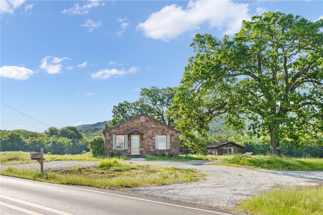 Rare chance to own a rock farmhouse on over an acre with Mountain views in your backyard.This unique house has had a total makeover inside and out.. Interior upgrades include completely redone bathroom. Including tiled shower, new vanity and granite. Kitchen has upgraded appliances, granite, sinks, backsplash and fixtures. The original hardwoods floors have been refinished to restore it to its natural beauty throughout the home. Roof, gutters and soffit are brand new. Donāt miss out on this rare gem. 10mins from the University of Arkansas. This home has also been upgraded to sewer. Wonāt last long!!!