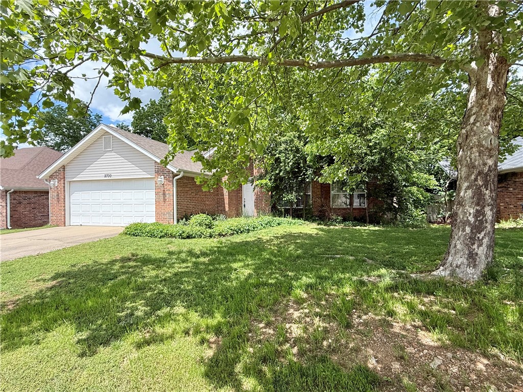 This open floor plan home features a spacious family room with soaring ceilings, a cozy fireplace, and a beautiful view of your private backyard. The 3-bedroom, 2-bath layout includes a dedicated office, abundant storage, and both a covered deck and a large lower-level deck—perfect for relaxing or entertaining. The kitchen comes with a refrigerator, and the washer and dryer also convey. Updates include a new roof (June 2020), hot water heater (May 2022), and flooring (Nov 2018) featuring LVP, carpet, and tile. Located in a desirable Bentonville neighborhood within walking/biking distance of the Razorback Greenway, this home offers comfort, convenience, and outdoor access all in one.