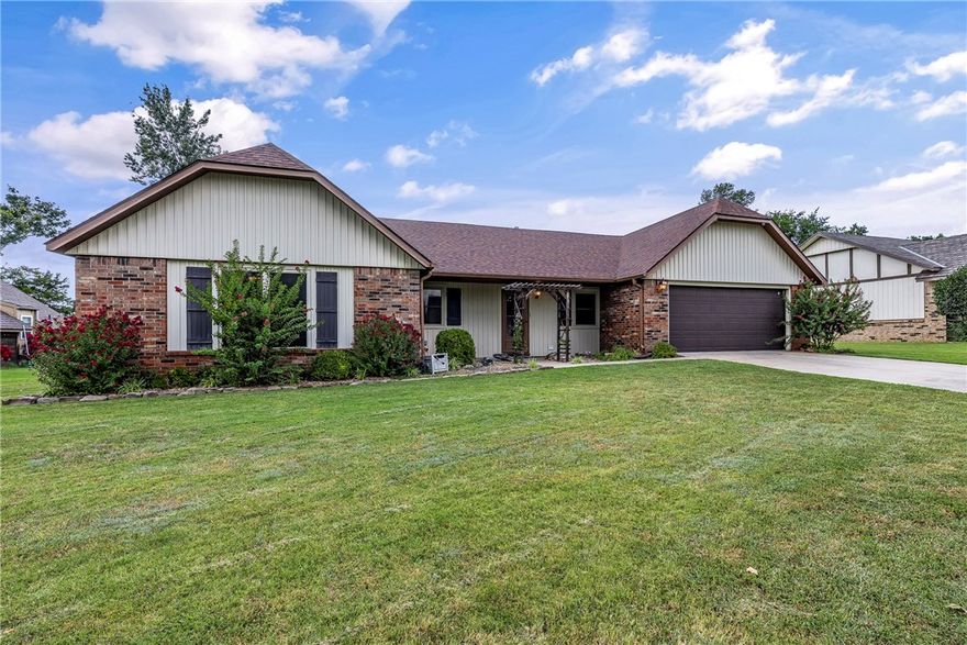This inviting 1,878 sqft home offers 3 bedrooms, 2 bathrooms, & sits on a spacious 0.28-acre lot w/ great curb appeal, highlighted by landscaped flower beds that give a warm first impression. Inside, you’ll find character & charm throughout. The living room features a beautiful, beamed ceiling, cozy gas bricked fireplace, & wood floors that create a welcoming atmosphere. A formal dining room provides the perfect setting for gatherings, while the sunroom, complete w/ skylights, brings in natural light year-round. Recent updates include fresh interior paint, new carpet, a new garage door opener, new sliding patio door, new fence & newer appliances. The backyard is a true standout. Along w/ plenty of space for gardening or outdoor enjoyment, you’ll love the large detached workshop w/ roll-up door & 220-volt outlet, ideal for hobbies, or additional storage. Unbeatable location Just minutes from the Rogers entertainment district, I-49 access, schools, & paved bike trails, it offers both convenience & lifestyle.