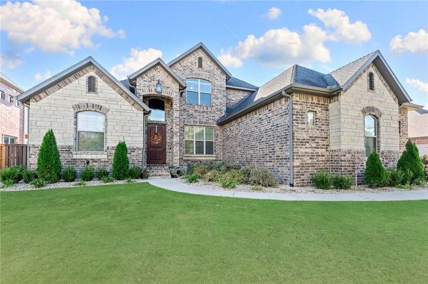 Located in the prestigious gated community of Oak Tree, this stunning home blends modern luxury with timeless elegance. Impeccably maintained, it features all brick and stone exterior, a covered patio with a gas/wood burning fireplace, built-in gas grill and a fenced, flat backyard with smart irrigation perfect for entertaining, play, or a future pool. The grand entry welcomes you to the formal dining and living areas with hardwood floors, gorgeous crown molding and gas fireplace. The chef’s kitchen showcases new Stainless Steel smart appliances, a five-burner gas range, double ovens, pot filler, granite countertops, bar seating, walk-in pantry, and a breakfast nook with hidden storage. The luxurious primary suite offers a walk-in shower, jetted tub and custom closet with built-ins. Three additional bedrooms downstairs and one bedroom upstairs feature walk-in closets. Other highlights include a mudroom, large laundry with sink and cabinetry, a theater room with 135" screen and projector, and walk-in attic storage.