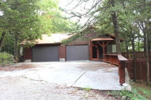 Custom built home on 12 ac m/l only minutes to town. Enjoy the privacy in the woods on one of the many decks or patios. Pasture that is fenced and cross fenced with two ponds and a 24x40 shop. Home features master suite, stone fireplace and vaulted ceilings in living room, large 2 car garage, four season room, walk out basement with 2 bedrooms, 1 bath. Newer metal roof and heat pump. Only minutes to Crooked Creek, White River, and Bull Shoals Lake.