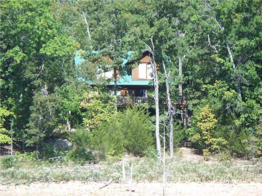 First time on the market, almost 23 acres with aprox, 2000ft of gentle walkdown lakefront.  Includes log cabin and private dock. Ready to develop or an excellent Corp or Family Retreat.  Located on open portion of Henry Hollow arm of Beaver Lake near,Point 5 and Starkey Marina by road. Has already been surveyed into 4 parcels.  Will not sell individually, must sell together