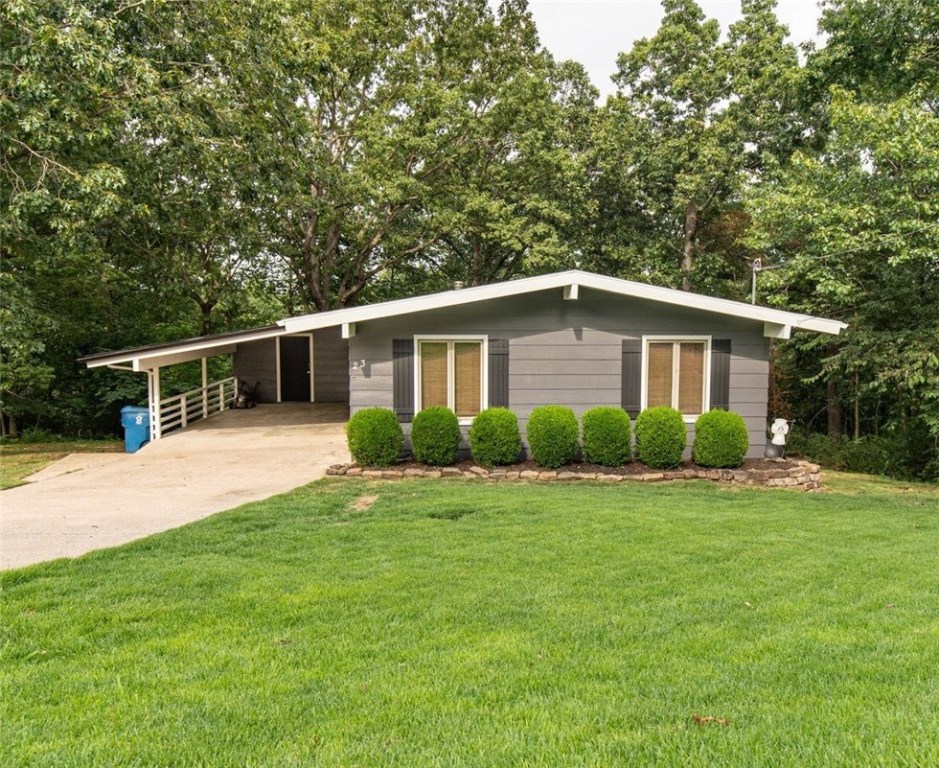 Updated & adorable! NEW KITCHEN with leathered granite, white cabinets, subway backsplash, stainless appliances, pantry, butcher block island. New exterior & interior paint. No carpet; floors are wood & ceramic. The living room adjoins the sun room which provides an extended living space for a comfortable home & for entertaining. Vaulted ceilings are in living & dining area. Main level has 2 bedrooms, 2 bathrooms. Lower level (walk-out basement) has 3rd bedroom; could use as office, bonus room, game room. The 3rd bathroom on lower level has walk-in shower. Large screened porch on main level with covered patio below. Ring doorbell doesn't convey; will replace. Crawlspace has 15' x 9.5' concrete area for storage space. Also, storage building 9'x12' in the back yard, and carport has 11' x 6' storage room. New Septic Tank 2013. Roof 2015. Wonderful location just 3 minutes to Kingsdale golf, swimming, tennis, playground, trails. Close to shopping, business centers, restaurants, medical, fire department, Hwy 71, and I-49
