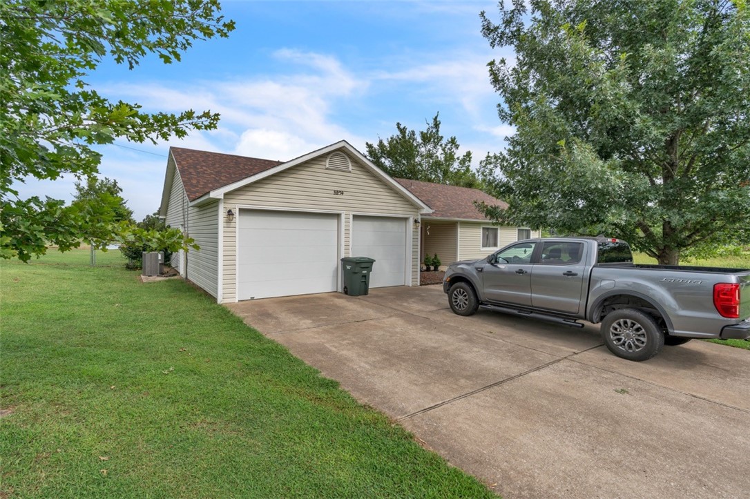 This 4-bedroom, 3-bathroom home is perfect for a homeowner or an aspiring developer. Ideally located just outside the city limits, it offers a peaceful country feel with the convenience of Lake Fayetteville just minutes away and quick access to all the amenities in both Fayetteville and Springdale. Recently updated with a new roof, HVAC system, and hot water tank, the home is designed for comfort and ease. The spacious interior includes ample storage, an attached double-bay garage, and a large detached single-bay shop with an extended metal roof carport. Set on 2 acres with significant street frontage, this property also offers excellent potential for future development. Enjoy the best of both worlds serene living with city conveniences close by.