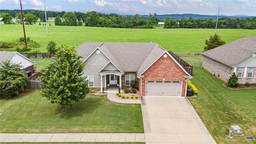 Welcome Home to Elegance and custom design over 2000 sq. Ft. Of heated and cooled space on a beautiful manicured lot in the city limits of Clarksville sets this-3 bedroom 2-full bath home. Largest suite has walk-in shower, separate tub and double sinks, and a walk-in closet. Tall ceilings, open floor plan, floor to ceiling windows and a corner gas log fireplace awaits you. Enjoy a MasterChef kitchen with granite countertops eat in kitchen also has a lovely island bar, All stainless steel appliances. There’s a private sitting porch that is  screened in overlooking your raised garden beds and secluded pasture land offering more privacy in your backyard. There is a 14 x 20 carport and a 12 x 20 out building with Electric H/A unit. Enjoy instant hot water with your recirculating system. There is also a pergola covered patio. The home is well insulated and has very low average utility bills. Large 2 car garage with extra storage. This beautiful home offers something for everyone in a great convent Location. Call today!