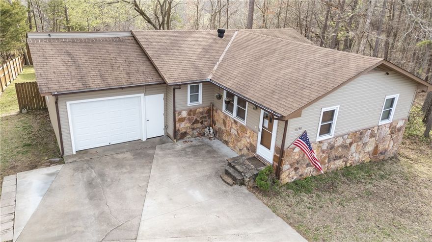 Come check out this amazing 5 bedroom home that is located in the pine trees near Beaver Lake! The walk out basement has been fully remodeled; including new paint, vinyl flooring, updated bathroom and light fixtures that provides lots of flexible space including office option, craft room option, and two sheds/workshops. Carpet in the living room was replaced in 2023 and new marble kitchen countertops! Enjoy the beautiful woods while relaxing on your back deck. There is boat launch access at the end of the street! Great opportunity for a STR.