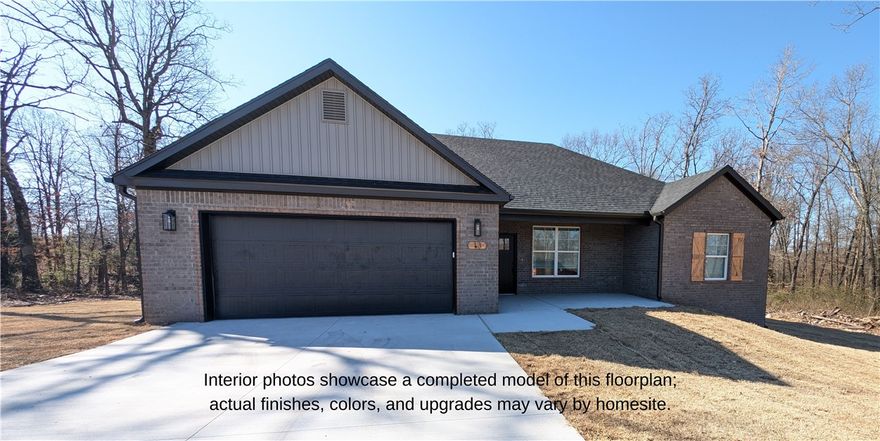 Nestled among the trees, this beautiful new 3-bedroom, 2-bathroom home features a classic brick-and-siding exterior that perfectly fits its tranquil setting. Inside, you'll find an expansive, open-concept floor plan designed for modern living. The heart of the home is the stunning kitchen, where light grey shaker cabinets, a distinct pattern tile backsplash, granite countertops, and sleek black hardware combine style and function. The living room provides a warm and inviting space with a sleek modern fireplace under a custom wood mantle, a feature that mirrors the home's striking wood shingle shutters outside. Thoughtful amenities include a dual-vanity master bathroom with gorgeous granite finishes, a sprawling walk-in closet with pre-built shelving, and a back deck that's perfect for entertaining. Contact us today for a tour! 
***House has a 2 bedroom septic system but three bedrooms.***