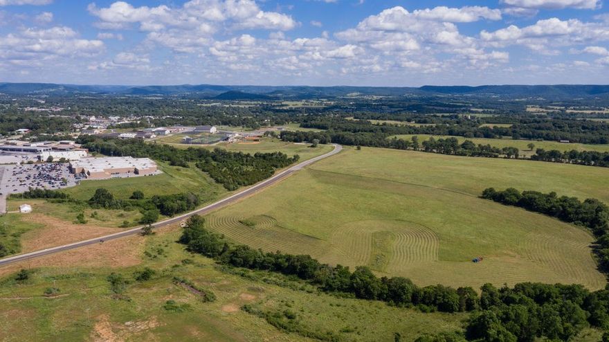 238 ac m/l Located in an Opportunity Zone.  Land Joins  Wal-Mart Supercenter, Berryville New Sports Complex , Elementary school, Carroll County Golf Course. West side of Berryville with access to Hwy 62.  130 ac of the land is in Berryville City Limits w/City Water, Sewer, Natural Gas. City will Re-Zone.  108 ac m/l is in the county, 2 homes, barn, pasture, stocked spring fed pond, wildlife.  Paved road on 2 sides of the property ( Freeman Street and Bunch Springs Rd ) and county road on 1 side ( cr 330) for a Total of 5200 ft of road frontage. Big Views of surrounding hills