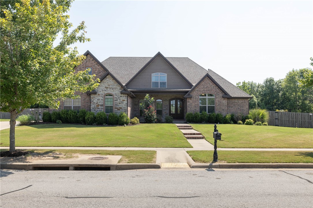 Beautiful home with very desirable floor plan situated on a 0.5 acre lot in West Fayetteville’s Prairie View Acres S/D. 3,639 heated and cooled sq ft offers 5 bedrooms, 4 full bathrooms, great room, eat in kitchen, hearth room, mudd room, and separate laundry. 2 bedrooms are located on the main level!! Other amenities include hardwood floors, stainless steel appliances, double pantries, intercom system, 3 car side load garage w/ epoxy floors, fully privacy fenced backyard, a covered grilling patio, and another patio for entertaining. Easy access to the I-49 corridor, shopping, and restaurants! Property backs up to a land trust for complete wooded privacy! Zoned for Holcomb Elementary.