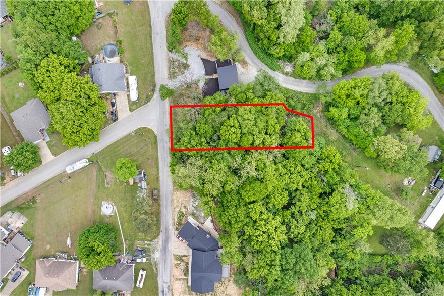 Beautifully positioned near Beaver Lake, this 0.26-acre lot offers an exceptional opportunity to build your dream getaway, full-time residence, or investment property in a scenic natural setting. Surrounded by the beauty of the Ozarks, the property provides a peaceful atmosphere with convenient access to boating, fishing, swimming, hiking, and all the outdoor recreation Beaver Lake is known for. Whether you're envisioning a cozy cabin retreat or a custom lake-area home, this lot offers the perfect canvas to bring your vision to life. Enjoy the tranquility of nature while still being within easy reach of nearby amenities, dining, and entertainment. A wonderful chance to own land near one of Springdales' most desirable destinations.