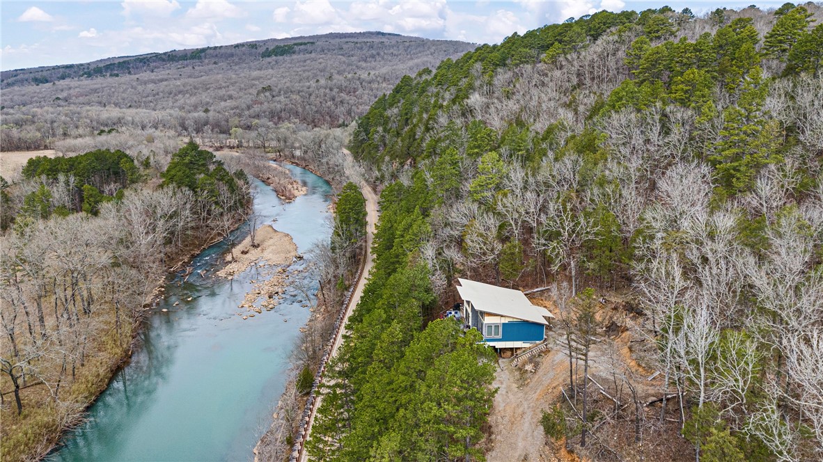Perched on a bluff overlooking the stunning Mulberry River and bordering the Ozark National Forest, this unbelievable unfinished cabin is your chance to create the ultimate getaway. Thoughtfully designed and full of potential, it offers a rare blend of privacy, adventure, and natural beauty. Whether you're dreaming of a serene vacation home or a high-demand weekend rental, this property delivers.With panoramic views, direct access to the National Forest, access to the mulberry, and approximately 3 acres of scenic, wooded terrain, the setting is nothing short of spectacular. With most of the material on site to finish and customize the interior/ exterior matching your vision. Enjoy a one-of-a-kind retreat nestled in the heart of Arkansas outdoor paradise.