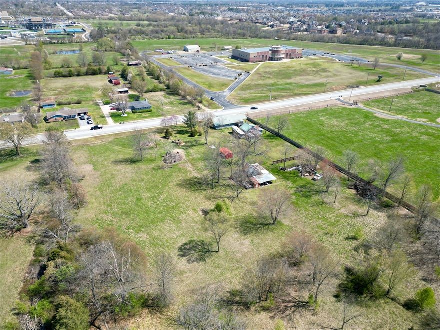 Original homestead property that has never been on the market before. 5 acres of flat land w/ development potential just minutes from the growing Pinnacle exit area. This rapidly developing area is located near I-49. It is home to several shopping centers, eateries, hotels, entertainment options & apartment complexes. The home was built in 1860’s with several additions added over the years. The property features 3 bedrooms & 1 bathroom w/laundry room, open dining room & 2 living areas. No central air on site. Two septic tanks feed to property. New metal roof. Has a nice covered back deck & covered front porch. An 880 sq ft custom shop that was built by family with 2 workspaces & stairs leading to an additional space that can be finished out. Land consists of 2 parcels & 2 additional sheds. Property sold as is with no seller repairs or credits. Value of property is in the land. All city utilities are at the street by the housel  Listed under land MLS #1242232 Residential MLS #1241758