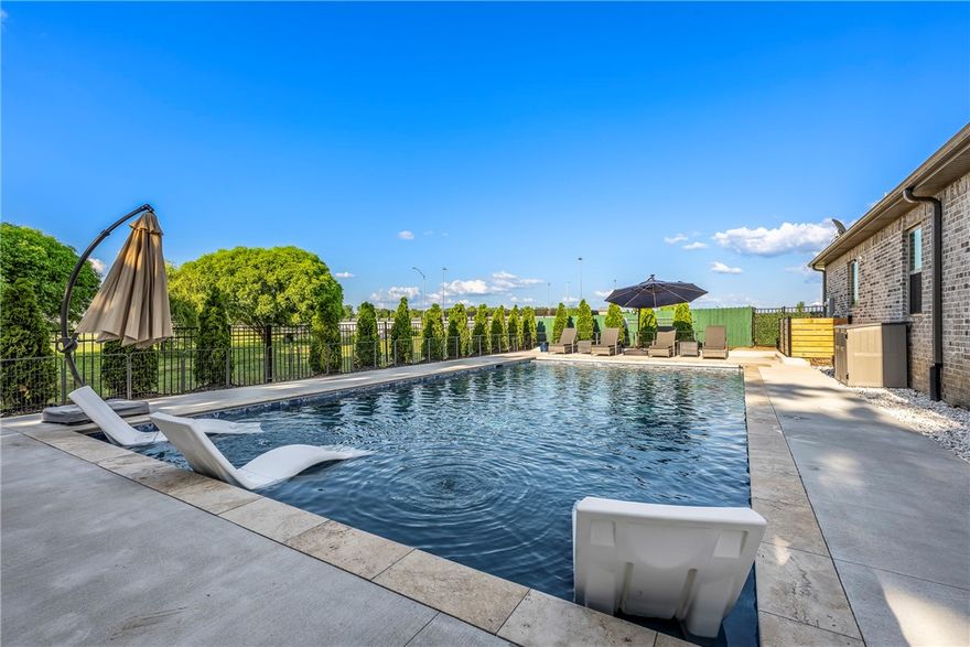 Welcome to your dream retreat! Set on a prominent 1.2-acre corner lot, this stunning home offers refined finishes, expansive living spaces, and a heated saltwater pool oasis. Step through the front double doors into an inviting layout. The open living room features a cathedral ceiling w/wood beams, a gas fireplace, and abundant natural light. The kitchen has granite countertops, a double oven, a pot filler faucet, and an oversized pantry. The main level includes a spacious primary with an en suite bathroom and walk-in closet, two bedrooms, and a bathroom. Upstairs, you'll find a bedroom with a large walk-in closet, bathroom, new carpet, and an unfinished attic—ready for your personal touch as a game room, bedroom, or storage. Sink your toes into the refreshing pool with an automatic cover and filler. Enjoy the garden with five raised beds—perfect for growing vegetables. Don't miss the 4-car garage with epoxy flooring. Conveniently located near Shaw Family Park, schools, restaurants, and more. Welcome home!