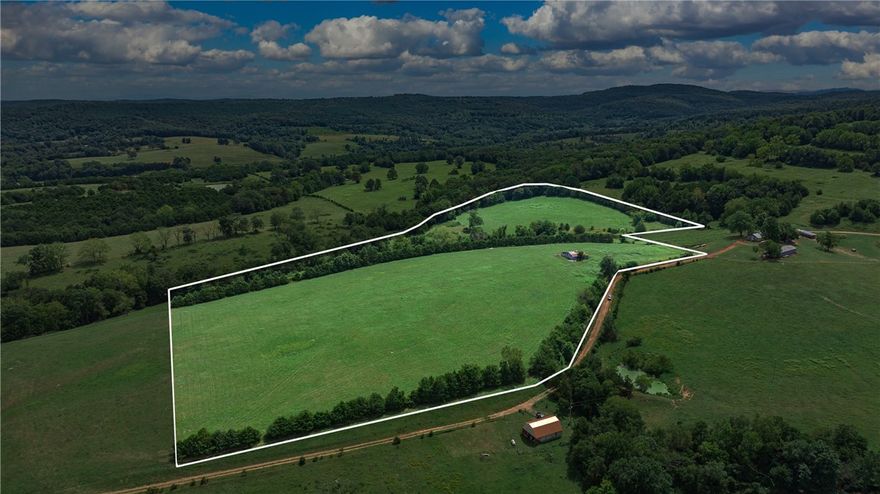 Discover the charm of country living on this idyllic 26-acre tract located amongst the rolling hills of Madison County. Currently used for hay, the land offers both functionality and breathtaking scenery. A spring-fed pond provides a serene centerpiece as well as a water source for livestock or wildlife.
The property also includes a hay barn. With its gently rolling terrain, open fields, and peaceful setting, this acreage is perfect for a small farm, ag use, or simply enjoying as a private retreat. Perc test and survey available 
If you’ve been dreaming of wide-open spaces and a slice of Ozark paradise, this property is ready to welcome you.