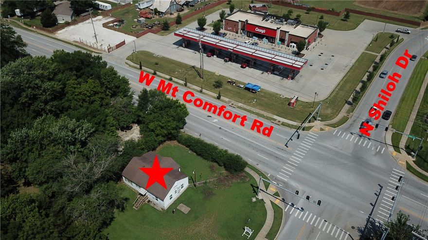 Perfect location for a fast food restaurant or a drive through coffee business. This is a corner lot location (hard corner) with a traffic light. Property is directly across Mt Comfort from a high volumn Casey's. Older house on the property is considered no value.
