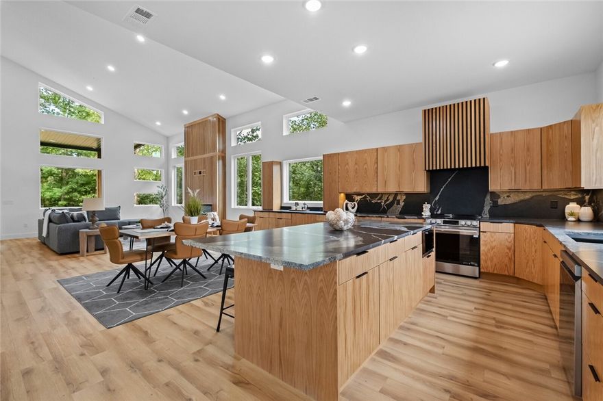 OFFERING UP TO 10K TOWARDS CLOSING COSTS OR RATE BUY DOWN. Welcome to this stunning modern new construction on a half-acre lot across from the Flo Ride Back Trail. This 4-bed, 2.5-bath, 2,495 sq ft home boasts high-end finishes, elegant details, and a thoughtful layout. Enter through the custom 8x4 ft solid wood door into an airy open floor plan with 20-ft ceilings and expansive picture windows framing breathtaking views. The chef’s kitchen features custom white oak cabinetry, high-level granite, designer backsplash, and a massive walk-in pantry. Bedrooms offer walk-in closets; baths include warm white oak accents. Solid 8-ft wood doors, a white oak fireplace, and double HVAC systems add quality and comfort. The epoxy-coated garage with built-in storage enhances function. The backyard is ideal for gardening or entertaining. With outdoor recreation steps away, this property blends luxury, comfort, and convenience. Don’t miss your chance to own this one-of-a-kind modern masterpiece.