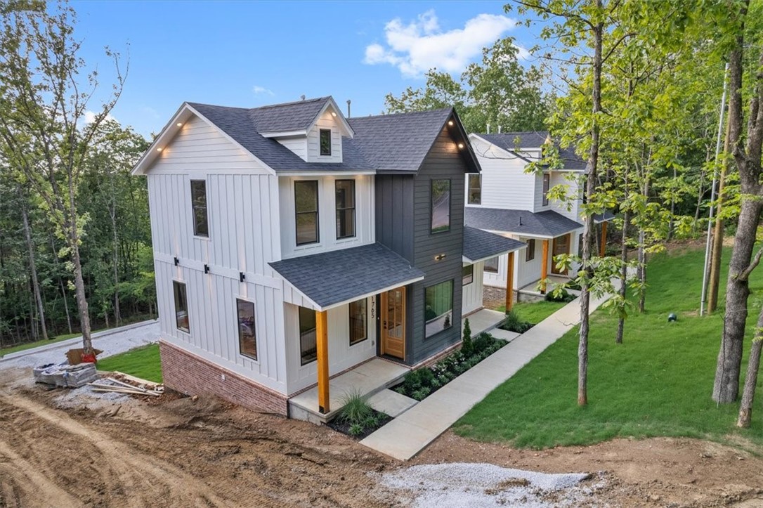 Gorgeous new construction home in the center of Fayetteville near the University of Arkansas and connected by sidewalks to trail systems. Enjoy four bedrooms each with an ensuite bathroom and tiled walk-in showers. Dual master bedrooms. Luxury features throughout the home including Delta fixtures and Frigidaire Professional appliances. Each floor is independently zoned with dedicated HVAC and insulated floors for sound proofing. Beautiful wood floors installed with premium carpet scheduled for installation soon. Walkout basement includes oversized two car garage and extra large driveway capable of hosting your visitors on game day weekends. Backyard is wooded on three sides with sunset views from WeatherBarr tinted windows. Deer are regular visitors. Two similar homes are also for sale next door.