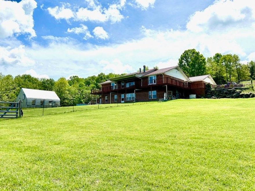 Stunning 6-bedroom, 3-bath brick home, situated on an impressive 67.75 acres of picturesque wooded and pasture land with breathtaking views of the Ozark Mountains. This remarkable property features two master bedrooms, on the main level, each with its own en-suite bathroom, ensuring ample space for comfort and privacy. The interior boasts two kitchens, two living rooms, a spacious walk-in pantry, an office/library, and extra storage/safety room. Outside, enjoy the tranquility of a large pond and the soothing sound of year-round Davis Creek flowing through the property. Additional amenities include a whole-house Generac generator that provides peace of mind, 21x12 metal storage building, a 24x24 greenhouse, perfect for gardening enthusiasts, and a chicken coop. Located on a paved county road, this home offers the perfect balance of seclusion and accessibility, being just 7.5 miles from the Buffalo River and 4 miles from the State Highway. Don't miss this unique opportunity to own a piece of paradise.