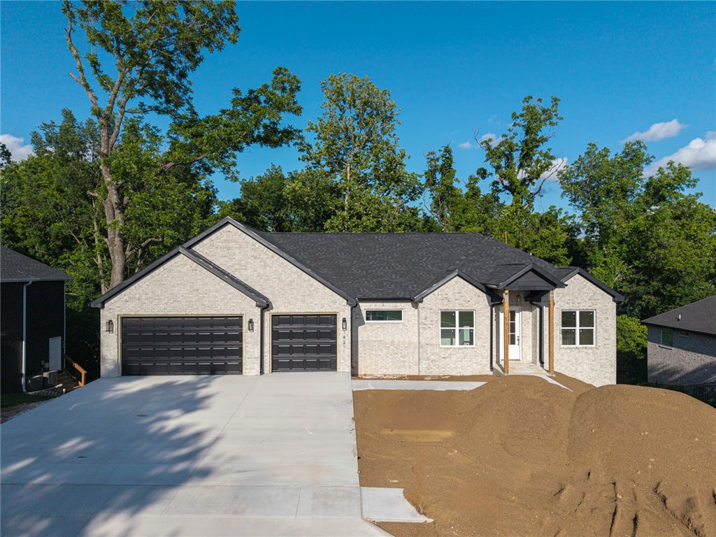 Builder is offering $10,000 in builder concessions! Located in the Big Sugar Golf Course subdivision, this stunning 5-bedroom, 3.5-bath home offers over 3,500 SF of beautifully finished living space—complete with a walkout basement and double decks overlooking mature trees. The main level features open-concept living, a spacious kitchen, walk-in pantry, laundry, and a private primary suite. Downstairs, enjoy two large flex spaces perfect for a game room, home gym, or office—plus plenty of storage. With scenic surroundings and golf cart–friendly streets, this home delivers comfort, flexibility, and that coveted golf course lifestyle in the heart of Pea Ridge!