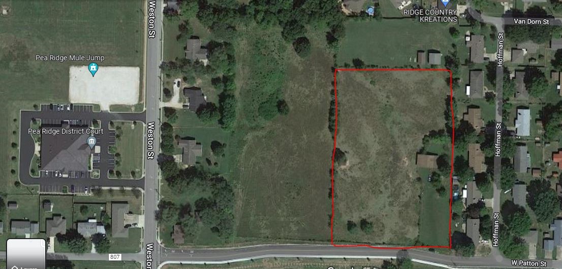Welcome Builders and/or Investors! Who is looking for a great parcel in the heart of Pea Ridge that is within walking distance to schools, the grocery store, auto parts, and the only place where you can dip your fries in a frosty? Well I found it! This piece of land is almost completely flat and perfect for some multi-family townhouses or a small neighborhood of new single family homes. The parcel has a small 1140 sq ft shop w/lean to where the owners restored and tinkered on many cars starting back in the 1960s. The land was also used to let their horses roam and the perfect field to teach their kids how to drive! The owners recently sold off the adjoining 4.32 acres that was rezoned and approved for R-2 Multi-family so that shouldn't be an issue for this parcel as well. There is electric on site and city water and sewer at the street. The parcel is 3.91 acres but the City of Pea Ridge took .37 acres in an easement to complete Patton Street so there is approximately 3.54 acres left to develop.
