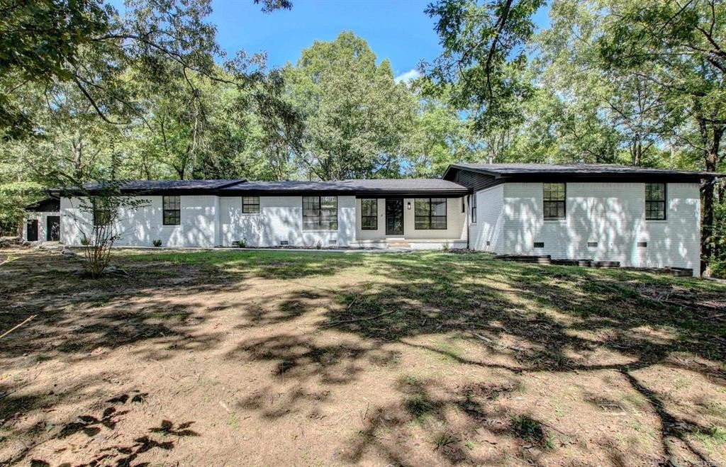 Nestled on nearly 3 acres in West Little Rock, this stunning home offers a perfect blend of convenience and seclusion. Fully renovated with modern finishes, the property boasts a primary suite on the main level, complemented by two spacious guest bedrooms. The lower level is ideal for in-law quarters or extended stays, featuring a bonus room, bathroom, bedroom, and kitchenette(separate entrance if needed). Many updates include a new roof, exterior paint, interior paint, lighting fixtures, plumbing fixtures and more (see attached feature list). Two-car garage attached with additional garage in shop. The tranquil outdoor spaces invite relaxation, with a heated and cooled sunroom off the primary bedroom, multiple decks for entertaining, and a charming flagstone patio with a firepit. Enjoy peaceful living in your own private oasis, just minutes from everything you need.