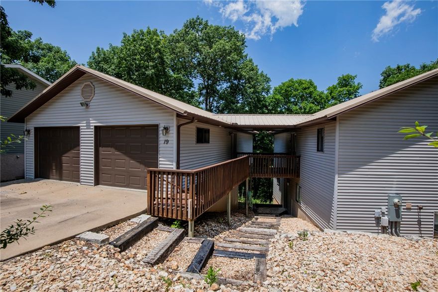 Tucked at the end of a quiet cul-de-sac & perched above the forest canopy, this 1-owner custom home offers privacy, tranquility & endless potential. Oversized windows flood the home w natural light—like living in a treehouse! Features 4 bdrm + bonus office/flex space or 5th bdrm, 4-car garage w covered breezeway, zero-maintenance yard & tons of storage including under-house access & walk-out lower level. Main floor offers true single-level living: primary suite, laundry, kitchen & living areas—all stair-free. Downstairs: 2nd living room, 2 bdrm, full bath, office & private entrance—ideal for multi-gen living or guest suite w kitchenette. Upgrades: brand new whole-house generator (leased 250-gal propane tank), metal roof, Culligan water filtration, massive pantry, abundant cabinetry & a blank canvas interior ready for your style. If you're seeking peaceful views, solid construction & room to grow—this is it. Schedule your private tour today! See attachements for plans, plat & SPD