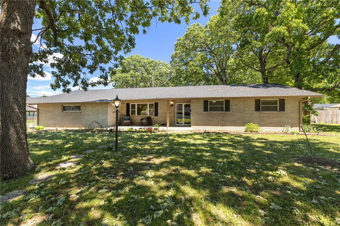 Get in to view this immaculately kept retro home on a large, flat corner lot with gorgeous mature trees! The large fireplace in the living room makes for perfect winters while the covered patio in the fully fenced backyard makes for perfect summers! We’re not sure if the original fixtures, layout, or lot size/price is our favorite thing about this home. New roof installed 2020. HVAC installed September of 2023. This one is low maintenance and ready to be lived in now. Would make for a perfect primary home or rental! Springdale is growing in the best ways with millions of development going towards improving down town. This property is near to retail, groceries, schools, medical facilities, veterinary care, and more. It takes nearly no time to hop on I49 from this location and be anywhere you need to be in NWA.