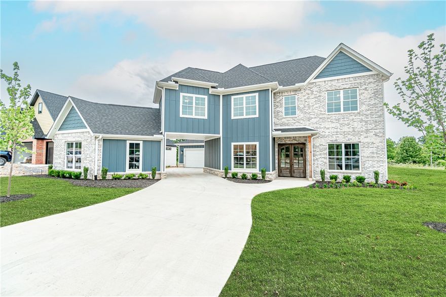 Stunning new construction home in a highly sought after neighborhood! This immaculate two story home features custom wood detailing throughout the home, open floor plan great for entertaining, and custom fireplace in the living area. The kitchen is a chef’s dream with its commercial grade appliances, large island with an abundance of counter space, and spacious walk-in pantry. The exquisite master suite features an ensuite bathroom complete with double vanity, large soaking tub, tiled rain shower, and spacious walk-in closet with custom shelving.  Enjoy warm summer evenings from your covered back patio complete with brick fireplace, mantle with space to mount a television, and ceiling fan to stay cool. Utilize the 3 car garage for extra storage and workspace. Located just minutes from Downtown Bentonville, local schools, and miles of walking and biking trails, this home has access to everything you need. Welcome home!