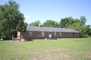Rare find in the county on 22 acres. Large brick home with 2 full living quarters. The upper level offers large living room, large custom kitchen with island, dining area, 3 BR 2 full BA. The lower level offers kitchen, living room, 2 BR 1.5 BA and utility room. The home also has a large deck that overlooks the property. 2 car garage with room ready for woodworking or storing your tools. The possibilities are endless. A lot of house for the money, priced for you to upgrade as you wish. Land is ready for cattle or horses, just add fencing.