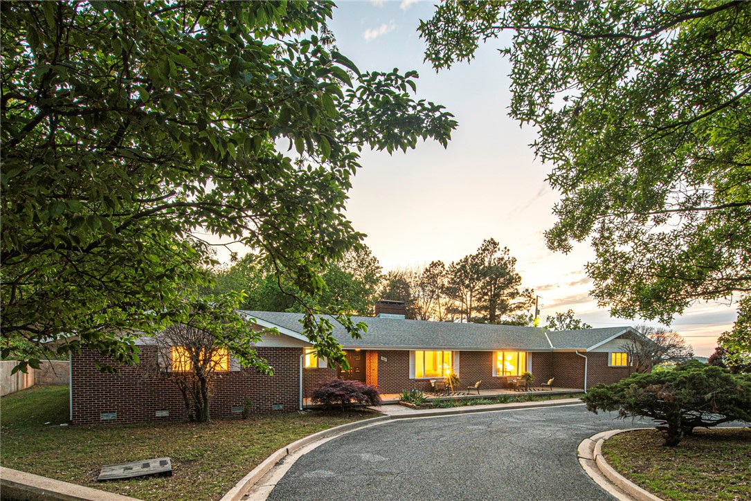 WELCOME HOME! This 4 Bedrm 2.5 Bathrm home on 1.06 Acres +/- is near corner of Garland and Wedington is a block away from the University of Arkansas & minutes away from I-49, parks, & downtown Fayetteville! From the circle drive & oversized front porch head inside w/ statement front door into a large foyer w/ coat closet! Entertain in the formal living & dining rm w/ fresh paint, new laminate wood flooring, oversized windows, & retractable room partition! Enjoy a U-Shaped kitchen w/ ample cabinetry! Unwind in the spacious great room w/ wood burning fireplace, built-ins, sliding door, ceiling fan & updated lighting! Relax in the oversized primary bedroom w/ ample closet space , built-ins & private ensuite bath feat:separate vanities & shower! Enjoy 3 addtl bedrooms & 1.5 bathrms! Head out back to the large patio overlooking the lawn w/ rock retaining walls & mature trees. PLUS: Workshop, Extra Storage! Don’t Miss Out on this home in one of Fayetteville's most desirable locations! property can not be developed!