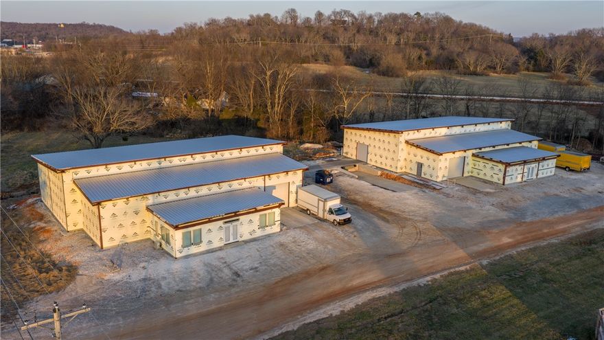 Public remarks-Prime Commercial Opportunity off the Greenland Exit! This versatile property features two 7,500 sq. ft. brand-new red iron construction warehouses, currently at 70% completion—offering the perfect chance for a buyer to customize the final finishes. Situated on ±2.5 acres with Hwy 265 frontage and immediate I-49 access, the site includes ample room for future expansion. Each building is designed with a dedicated front office area, rear warehouse space, one dock-high door, and one grade-level roll-up door. Large gravel parking lot included. One building has a current lease situation. Don't miss this high-visibility, high-growth location! Sold as-is at current stage of construction.